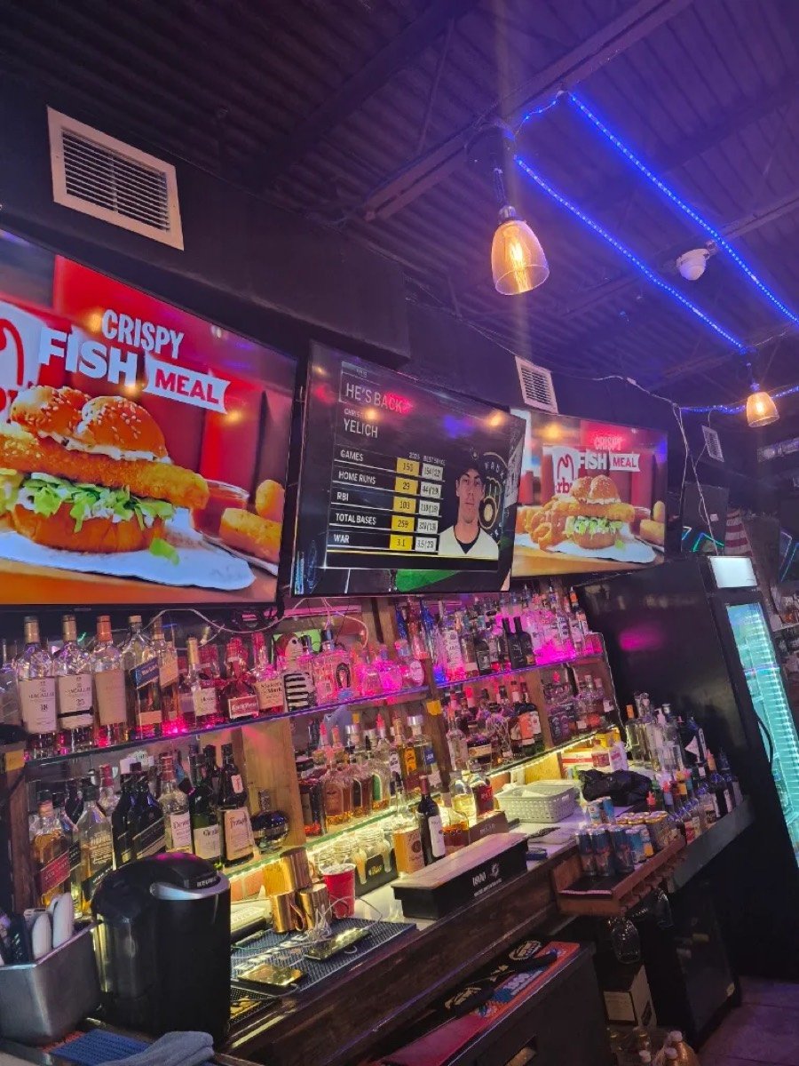 Back bar with sports on TV at Shooterz Lounge